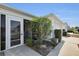 Exterior view with landscaped gravel bed and flowering shrubbery at 2111 Thornton Ter, The Villages, FL 32162
