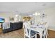 Open concept living and dining area featuring wood floors, comfortable seating, and ample natural light at 2111 Thornton Ter, The Villages, FL 32162