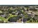 Aerial view of a home showcasing its surroundings, including lush greenery and a pond at 21206 Canoe Pass St, Clermont, FL 34715