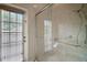 Modern bathroom with a glass shower enclosure, showerhead, shower bars and a window providing natural light at 21206 Canoe Pass St, Clermont, FL 34715