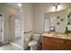 Bathroom featuring a glass door shower, a toilet, and a vanity with a sink at 21206 Canoe Pass St, Clermont, FL 34715