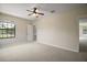 Bright bedroom featuring neutral walls, carpet flooring, ceiling fan and a window with natural light at 21206 Canoe Pass St, Clermont, FL 34715