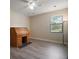 Neutral bedroom with wood floors, a window with blinds, and a wooden rolltop desk at 21206 Canoe Pass St, Clermont, FL 34715