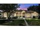 Charming stone and stucco home with landscaped yard, paver walkway, and arched entryway on a well maintained lawn at 21206 Canoe Pass St, Clermont, FL 34715