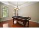 Game room featuring hardwood floors, a coffered ceiling, a chandelier, and a classic pool table at 21206 Canoe Pass St, Clermont, FL 34715
