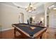 Open view of the game room showcases a pool table and a glimpse into the adjacent living area at 21206 Canoe Pass St, Clermont, FL 34715