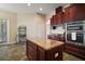 Kitchen boasting a center island with granite countertops and stainless steel appliances at 21206 Canoe Pass St, Clermont, FL 34715