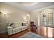 Inviting living room with hardwood floors, tray ceiling, comfortable seating, and an arched doorway at 21206 Canoe Pass St, Clermont, FL 34715