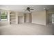 Open living room with built-in shelves, recessed lighting, carpet, ceiling fan and a window at 21206 Canoe Pass St, Clermont, FL 34715