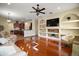 Bright open living room featuring custom built-ins, hardwood floors, and neutral paint at 21206 Canoe Pass St, Clermont, FL 34715