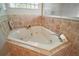 Large bathtub with tile surround and glass block windows provide natural light at 21206 Canoe Pass St, Clermont, FL 34715