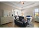 Spacious main bedroom showcasing a coffered ceiling, an en suite sitting area, and plenty of natural light at 21206 Canoe Pass St, Clermont, FL 34715