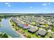 Aerial perspective of a home with beautiful lake views, situated in a neighborhood with scenic surroundings and modern living at 2321 Demarco Dr, The Villages, FL 32163