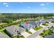 Gorgeous aerial shot of a home with water views, surrounded by lush greenery and scenic beauty in a peaceful neighborhood at 2321 Demarco Dr, The Villages, FL 32163