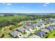 Stunning aerial view of a home with lush landscaping and a tranquil pond, offering a serene and picturesque setting at 2321 Demarco Dr, The Villages, FL 32163