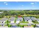 Aerial view of a home with well-kept lawns and landscaping, situated on a tranquil pond in a scenic neighborhood at 2321 Demarco Dr, The Villages, FL 32163