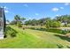 Expansive backyard with lush lawn and serene pond view, perfect for outdoor activities and tranquil relaxation at 2321 Demarco Dr, The Villages, FL 32163