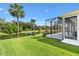 Enjoy the expansive backyard and scenic pond view from the home's screened-in lanai at 2321 Demarco Dr, The Villages, FL 32163
