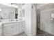 Bathroom featuring a large mirror over the vanity and a walk-in shower with stylish tile work at 2321 Demarco Dr, The Villages, FL 32163