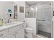 Modern bathroom featuring tiled walk-in shower, gray tile, and white vanity at 2321 Demarco Dr, The Villages, FL 32163