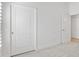 Bedroom featuring a closed door and a partially open closet door at 2321 Demarco Dr, The Villages, FL 32163