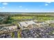 Aerial view of a shopping center with ample parking, showcasing the retail amenities in the surrounding community at 2321 Demarco Dr, The Villages, FL 32163