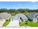 Attractive home with manicured landscaping and a spacious driveway, nestled in a serene setting with beautiful water views at 2321 Demarco Dr, The Villages, FL 32163