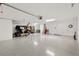 Large garage with golf cart, bicycle, epoxy floor and door to the house at 2321 Demarco Dr, The Villages, FL 32163