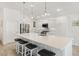 Bright kitchen featuring an island with bar seating, stainless steel appliances, and pendant lighting at 2321 Demarco Dr, The Villages, FL 32163