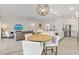 Open-concept living and dining area with pendant lighting, island seating, and a comfortable seating area at 2321 Demarco Dr, The Villages, FL 32163