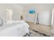This bedroom features wood-look tile flooring, beach decor, and ample natural light at 2321 Demarco Dr, The Villages, FL 32163