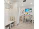 Bright office with a beach-themed tv show and a Welcome Home sign above the bench at 2321 Demarco Dr, The Villages, FL 32163