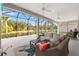 Screened lanai with comfortable seating and beautiful outdoor view of the landscape at 2321 Demarco Dr, The Villages, FL 32163