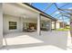 A spacious covered patio features ceiling fans and access to the home's interior through sliding glass doors at 2321 Demarco Dr, The Villages, FL 32163