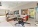 Inviting screened patio with comfortable seating, ceiling fans, and outdoor TV at 2321 Demarco Dr, The Villages, FL 32163