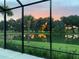 Relax on the screened lanai and witness the golden sunrise reflecting off the tranquil pond, surrounded by lush greenery at 2321 Demarco Dr, The Villages, FL 32163