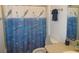 Charming bathroom with dolphin-themed shower curtain, adding a playful touch to the space at 2388 Branchville Ter, The Villages, FL 32162