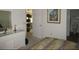 Comfortable bedroom features artwork, a dresser, and access to an ensuite bathroom and another room at 2388 Branchville Ter, The Villages, FL 32162
