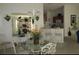 Well-lit dining area with decorative chandelier adjacent to the kitchen, creating an inviting space at 2388 Branchville Ter, The Villages, FL 32162