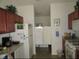 Functional kitchen featuring essential appliances and ample counter space with view to eat-in kitchen at 2388 Branchville Ter, The Villages, FL 32162