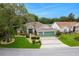 Beautiful aerial view of a home with a three-car garage, manicured landscaping, and inviting curb appeal at 25236 Waterbridge Ct, Leesburg, FL 34748