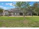 Spacious backyard with manicured lawn and screened patio area provides ample space for outdoor activities at 25236 Waterbridge Ct, Leesburg, FL 34748