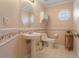 Cozy bathroom features floral wallpaper, pedestal sink, and shuttered window at 25236 Waterbridge Ct, Leesburg, FL 34748