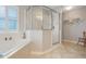 Bright bathroom offers a soaking tub with tile surround and a glass shower enclosure at 25236 Waterbridge Ct, Leesburg, FL 34748