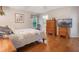 Cozy bedroom with hardwood floors, a floral quilt, and a window offering natural light at 25236 Waterbridge Ct, Leesburg, FL 34748