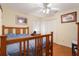 Bedroom features wood floors, white walls, and natural light from an adjacent window at 25236 Waterbridge Ct, Leesburg, FL 34748