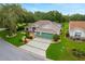 Beautiful single-Gathering home with a two-car garage, lush landscaping, and a well manicured lawn in a desirable area at 25236 Waterbridge Ct, Leesburg, FL 34748