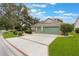 Charming single-story home with a three-car garage, well-manicured landscaping, and a welcoming curb appeal at 25236 Waterbridge Ct, Leesburg, FL 34748