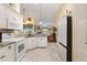 Bright, open kitchen with white appliances, granite countertops, and easy access to the living area at 25236 Waterbridge Ct, Leesburg, FL 34748