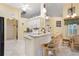 Eat-in kitchen featuring granite countertops, arched doorways, white cabinets, and counter seating at 25236 Waterbridge Ct, Leesburg, FL 34748